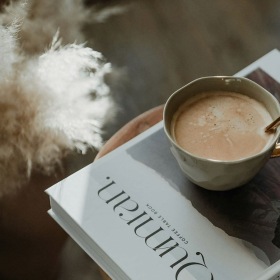 a cup of coffee on a book