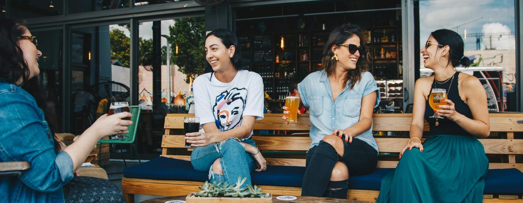 a group of people sitting at a table with drinks